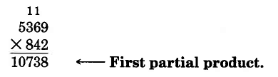Vertical multiplication. 5369 times 842, with the first part of the product, 10738, in the first line of the product space. A 1 is carried above the 6, and a 1 is carried above the 3. 10738 is labeled, first partial product.