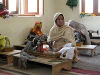 A picture of a woman sitting at a small table.