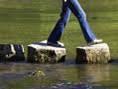 a person walking on stepping stones