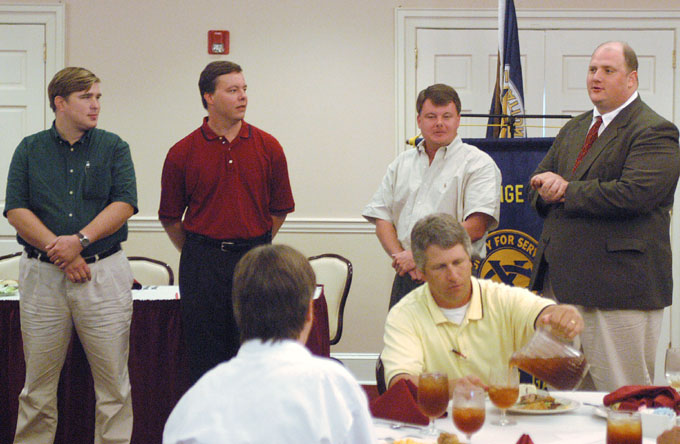 men standing giving a presentation