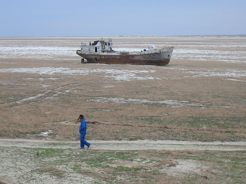 a photograph of an abandoned ship in a dried up lake bed that was the Aral Sea