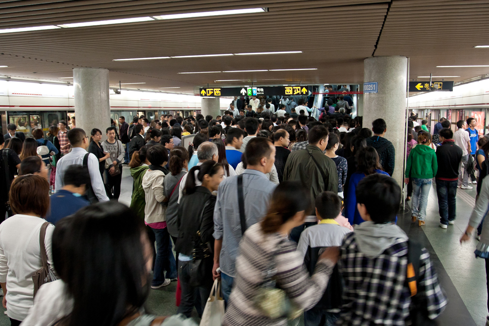 People walking around a crowded subway station are shown here