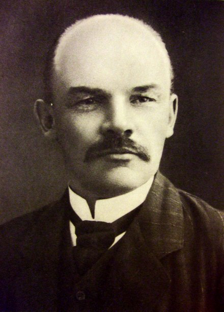 In figure (a), a photograph of Vladimir Ilyich Lenin is shown.