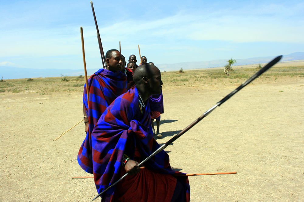 Men carrying staves and spears are shown.