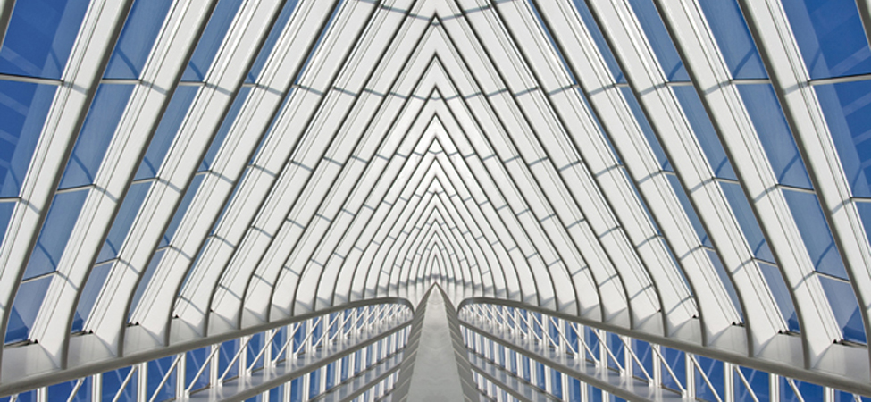 Part of a glass building is shown. The structure is made up of individual shapes.