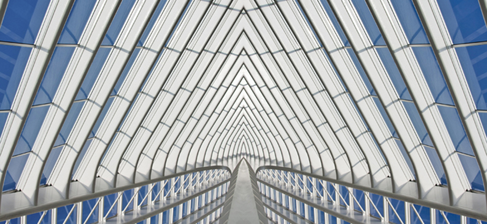 Part of a glass building is shown. The structure is made up of individual shapes.