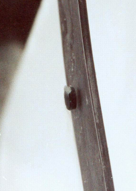 The figure shows a button-shaped magnet floating above a superconducting puck. Some wispy fog is flowing from the puck.