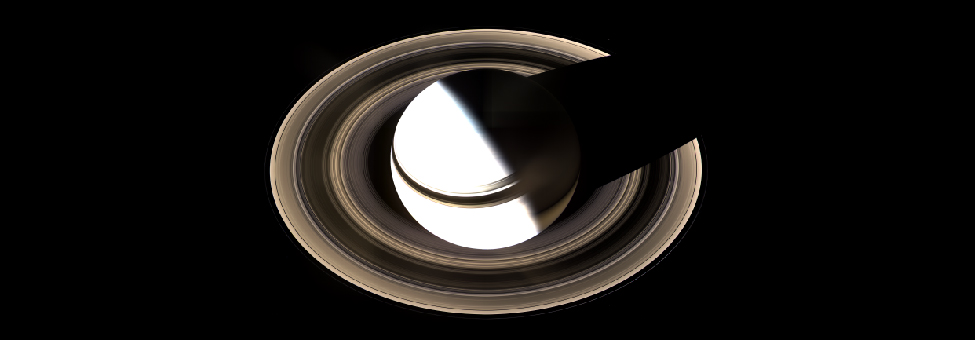 Image of Saturn and its Rings. Taken almost directly over one of Saturn’s poles, the rings are seen nearly face-on, completely encircling the planet. Sunlight arrives from lower left as the rings cast a thin shadow on Saturn’s cloud tops, while Saturn itself casts a shadow on the rings at upper right.