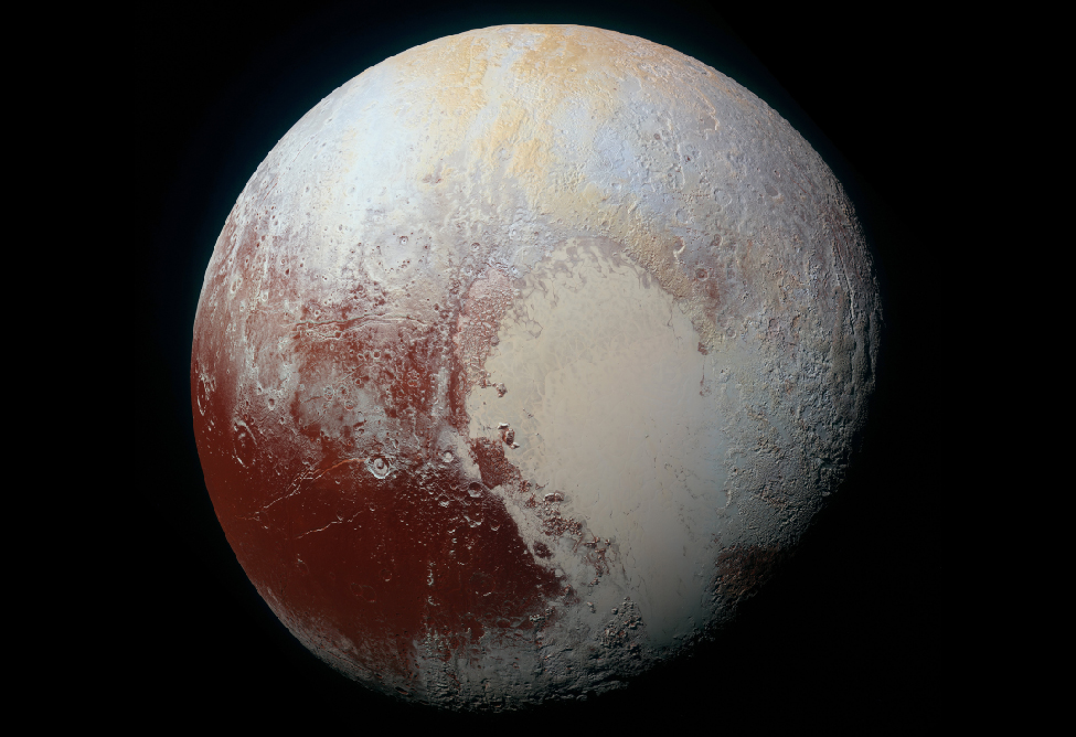 A global color image of Pluto, showing a dark area in the lower left covered with impact craters, and a larger light area in the center and lower right that is flat.