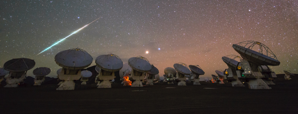 A photo of a falling meteor with a trail of light behind it.